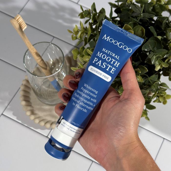 MooGoo Natural Moothpaste whitening peppermint toothpaste in bathroom, fluoride-free toothpaste with hydroxyapatite for dental health