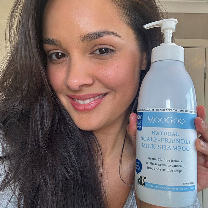 MooGoo Sensitive Scalp Milk Shampoo held in hand, sulphate-free cleanser for scalp irritation