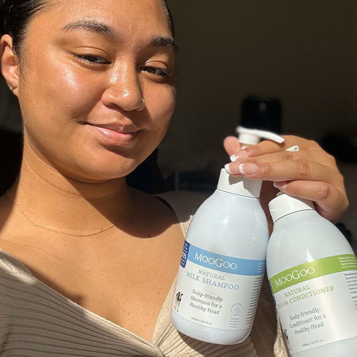 MooGoo Natural Sensitive Scalp Milk Shampoo shown with smiling woman, gentle sulphate-free hair care
